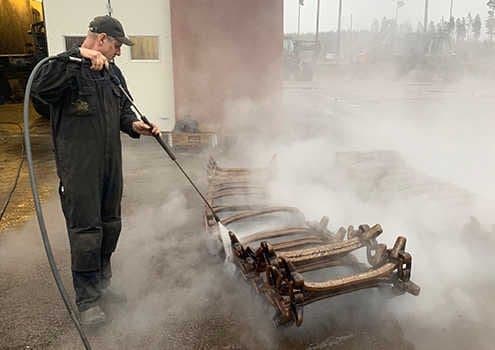 Tracks being cleaned with a pressure washer