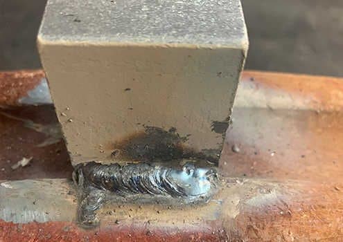 Weld string along the long side of the stud